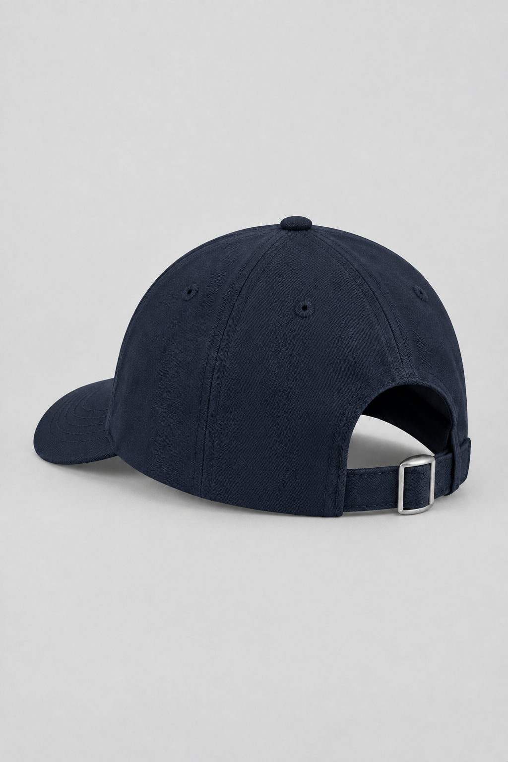 Commercial rear-view packshot of the navy cap on a light gray seamless backdrop